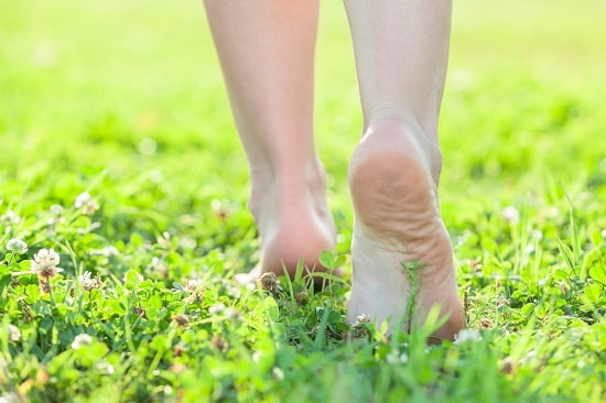 person-walking-on-grass-summer-vacation-ideas